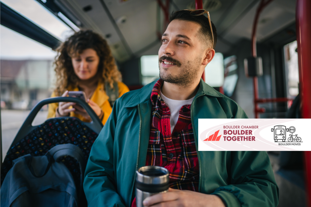 A photo of two people sitting on a city bus. In the background, a woman looks at her cell phone. In the foreground, a man with a mustache holds a travel mug and smiles as he looks out the window. The Boulder Chamber Boulder Together logo is superimposed on the photograph in the center right.