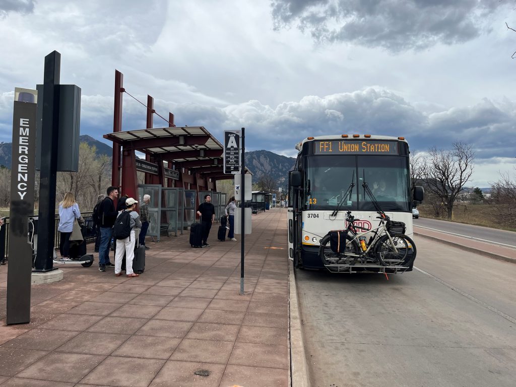 An outbound Flatiron Flyer bus picks up passengers at Gate A on the south side of US 36. 