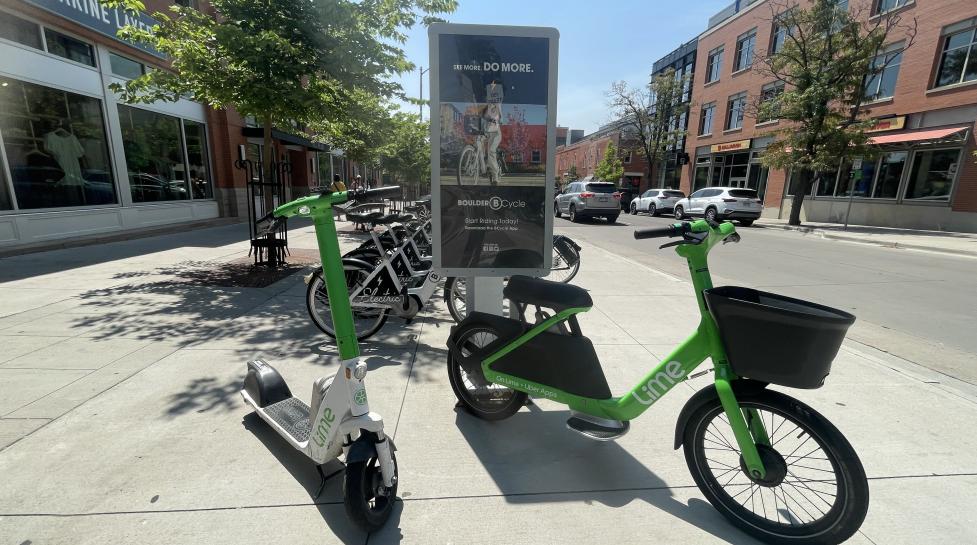 An image of a BCycle station with a Lime e-scooter and LimeGlider in front
